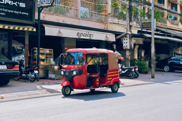 Tuk-tuk circulant dans une rue anim&eacute;e au Cambodge