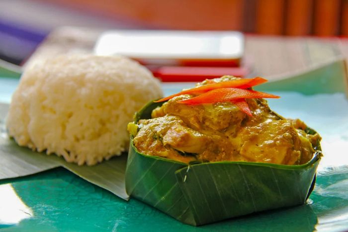 Dégustez le amok, un poisson cuit à la vapeur dans une feuille de bananier avec une sauce au lait de coco et aux épices