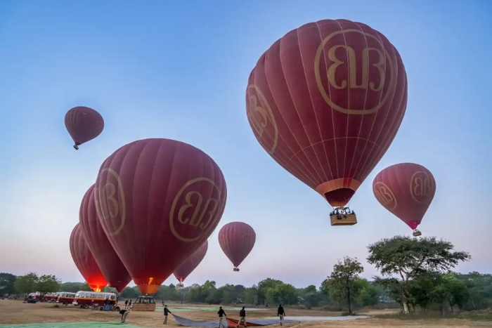 Des montgolfières emmènent les touristes dans les airs pour admirer la vue panoramique de Bagan