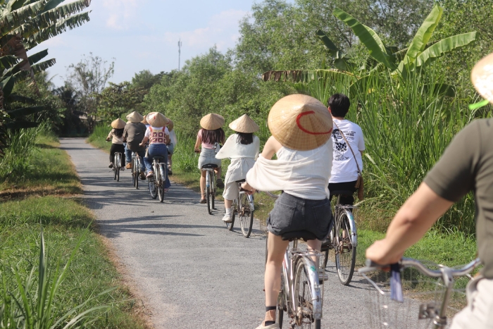 P&eacute;daler &agrave; travers les rizi&egrave;res verdoyantes du sud du Vietnam